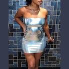 Woman wearing a strapless silver bodycon mini dress with a shiny metallic finish