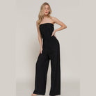Chic black strapless tube jumpsuit with a fitted bodice and wide-leg pants for stylish summer outings