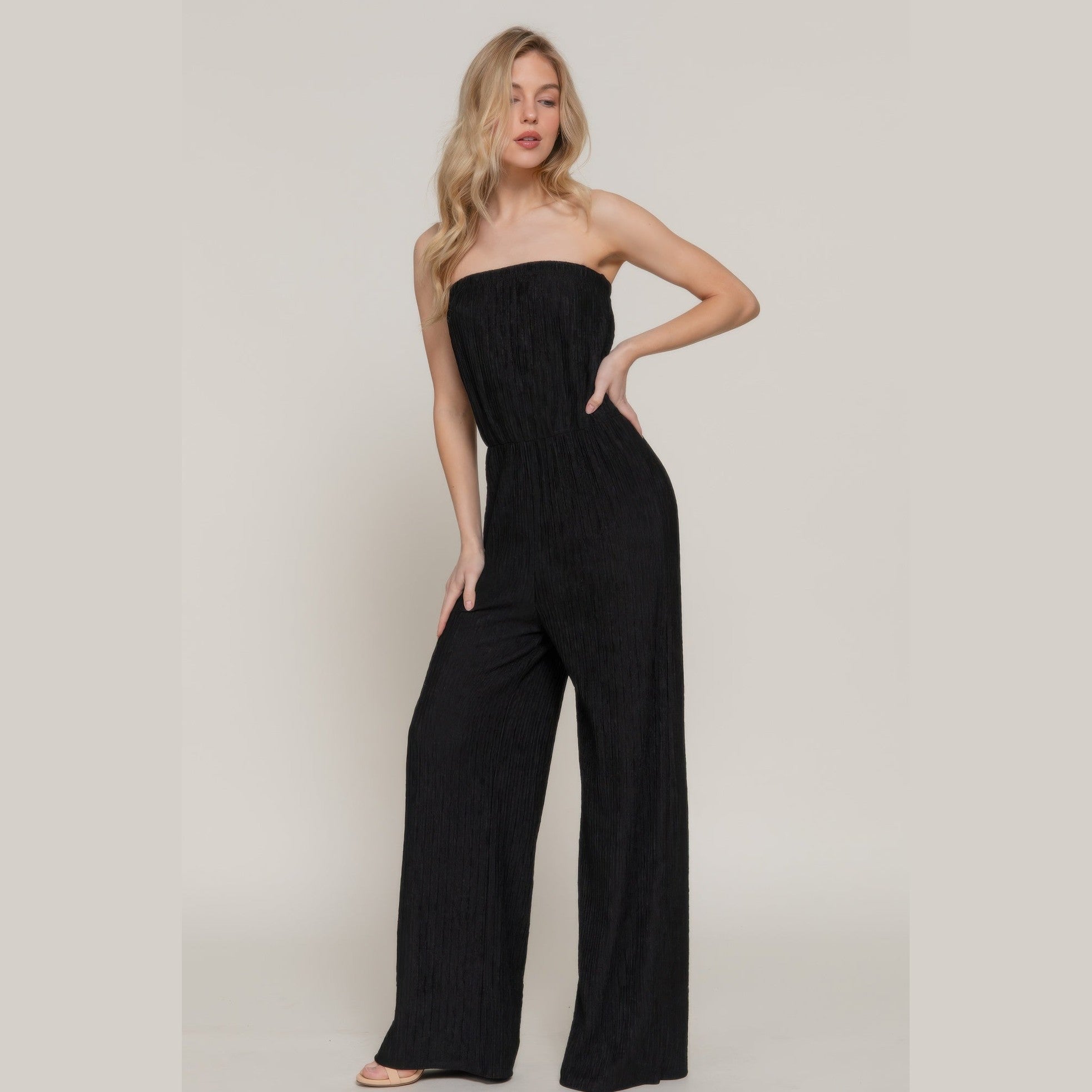 Chic black strapless tube jumpsuit with a fitted bodice and wide-leg pants for stylish summer outings