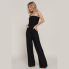Elegant black strapless tube jumpsuit by VacationGrabs, featuring a sleek design and wide leg for a stylish look