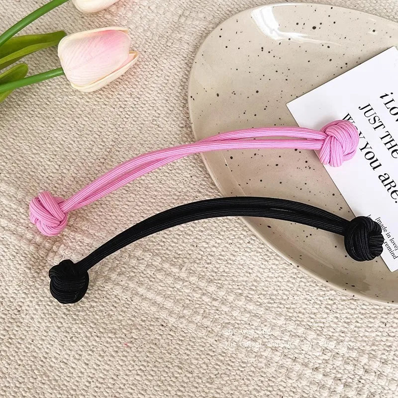 Stretch rubber hair ties for women in pink and black colors