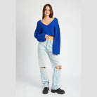 Emory Park stylish blue crop top with long sleeves paired with distressed jeans for a trendy look