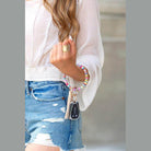 Colorful stylish bracelet key holder with tassel attached to keys, worn on the wrist