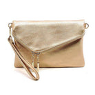 Chic gold clutch bag, a stylish handbag for vacation with a sleek design and wrist strap