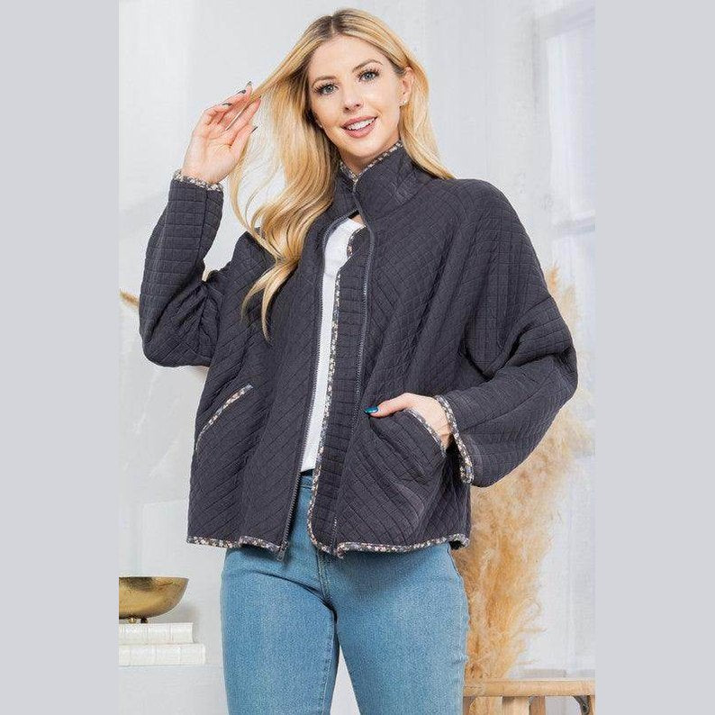 Stylish quilted coat from Orange Farm Clothing with a relaxed fit and contrasting trim for women