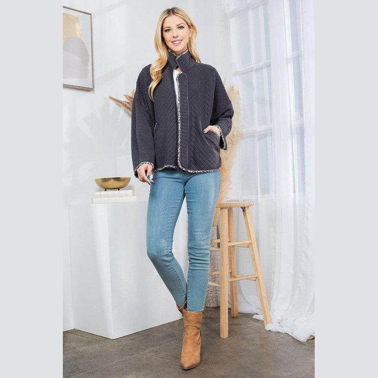 Stylish quilted coat by Orange Farm Clothing, paired with jeans and ankle boots for a chic look