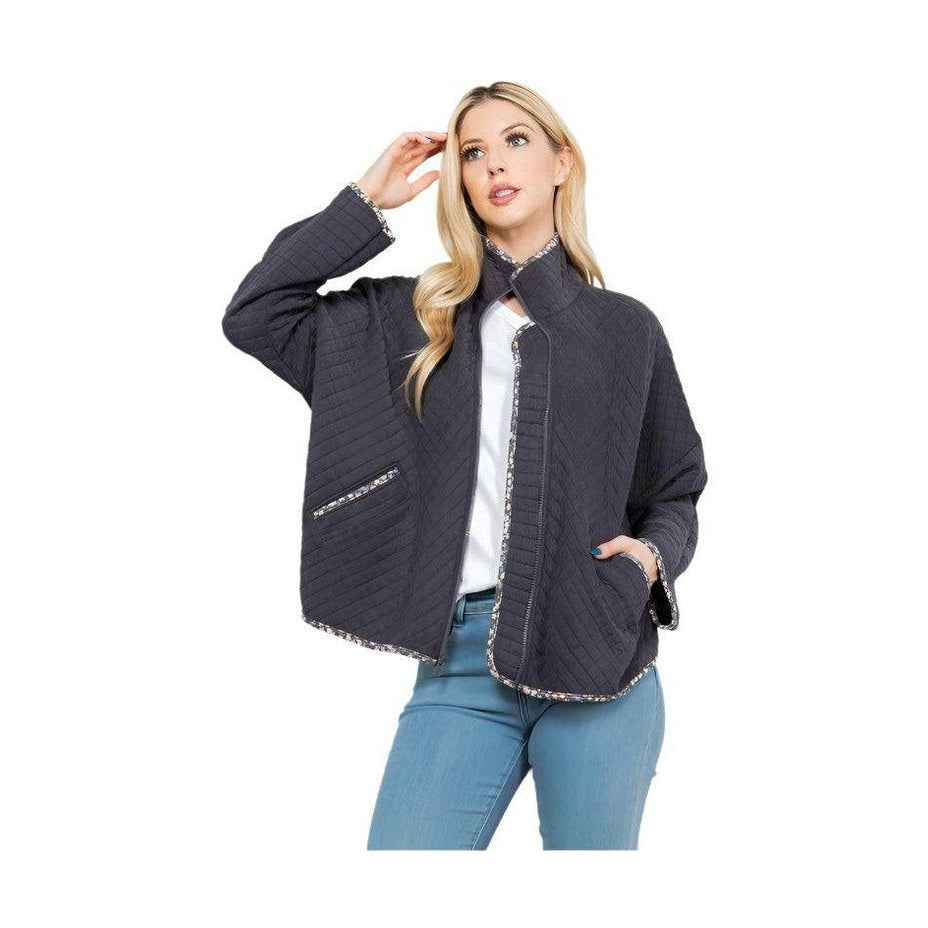 Women's stylish quilted coat from Orange Farm Clothing with a modern design and convenient pockets