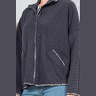 Stylish quilted coat from Orange Farm Clothing with floral hem and zip-up closure