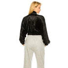 Back view of a women's stylish travel jacket from Andante USA in black with a cropped design