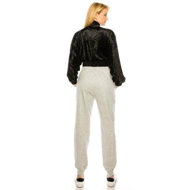 Back view of a stylish travel jacket for women in black velvet with a cinched waist