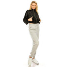 Andante USA stylish travel jacket in black, paired with gray sweatpants for a chic look