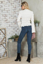 Back view of a stylish vacation blouse from Andante USA paired with fitted jeans and boots
