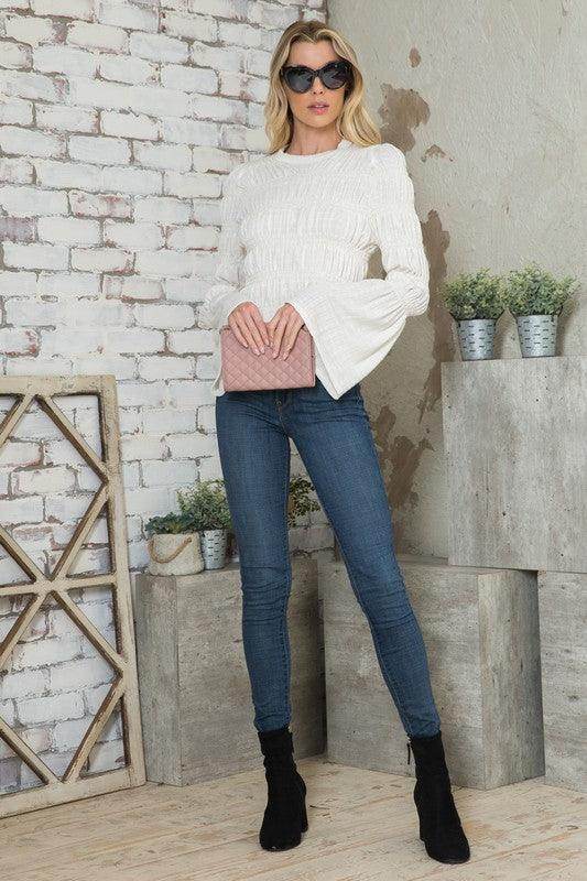 White Andante USA stylish vacation blouse with flared sleeves paired with jeans for a chic look