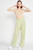 Emory Park stylish vacation crop top in beige paired with light green pants for a trendy summer look