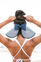 Stylish vacation sun hat from Aili's Corner with a wide brim and bow detail, perfect for beach outings
