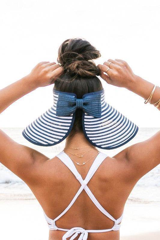 Stylish vacation sun hat from Aili's Corner with a wide brim and bow detail, perfect for beach outings