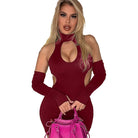 Woman wearing a burgundy summer club halter dress for women with cutouts and matching arm sleeves holding a pink handbag