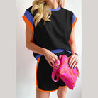 YNIQUE stylish summer vacation two piece outfit with black top and shorts trimmed in blue and orange
