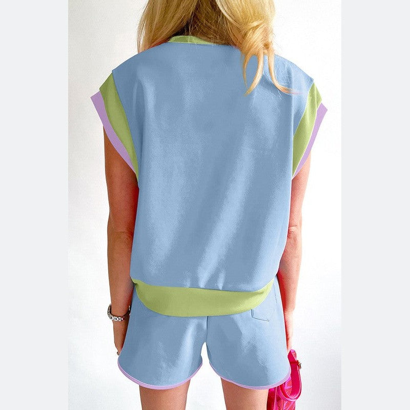 YNIQUE summer vacation two piece outfit with pastel blue top and matching shorts with green and purple accents