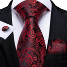 Elegant red and black paisley design men's necktie featuring a matching pocket square and cufflinks
