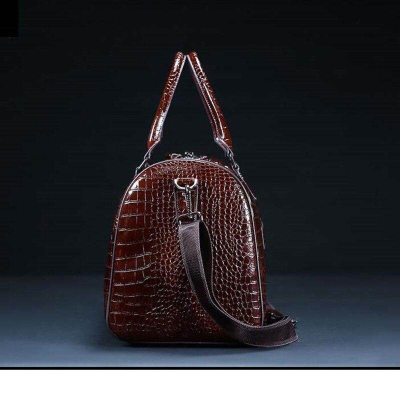 Textured leather travel bag in dark brown with sturdy handles and a detachable strap for easy carrying