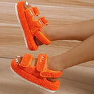 Bright orange thick bottom casual sandals with adjustable straps for a comfortable fit