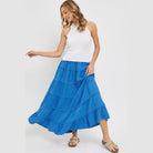 VacationGrabs blue tiered maxi skirt for women paired with white sleeveless top and sandals
