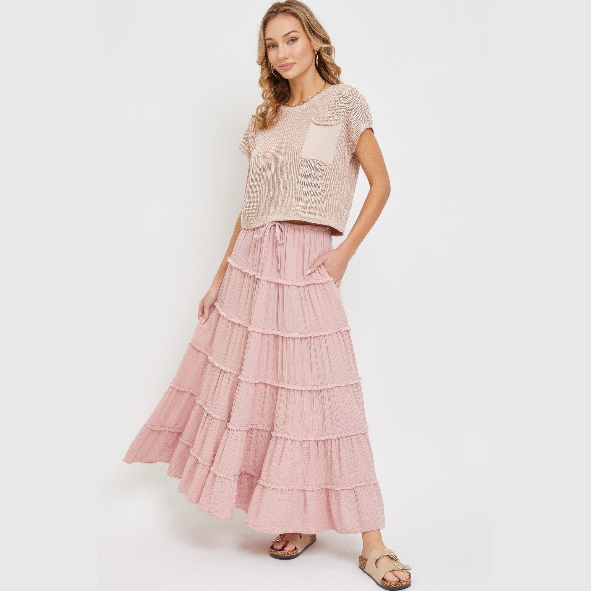 VacationGrabs pink tiered maxi skirt for women styled with a beige short sleeve top and sandals