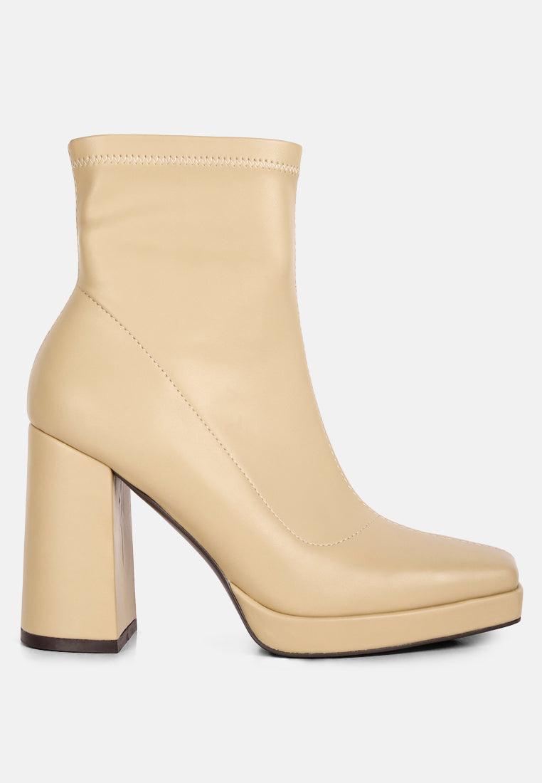Beige ankle boot with a block heel on a white background