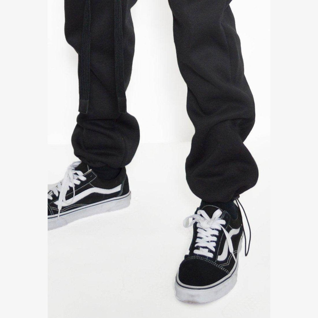 Men's activewear featuring black toggle sweats for men paired with stylish sneakers