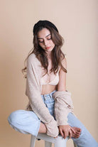 Stylish woman wearing a topknot headband for women with casual outfit in a studio setting