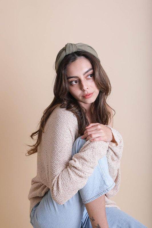 Leto Accessories topknot headband for women in soft green showcased on a model with casual clothing