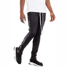 Men's trendy leather stripe joggers by WEIV in black with side leather stripes styled with white shirt and black sneakers