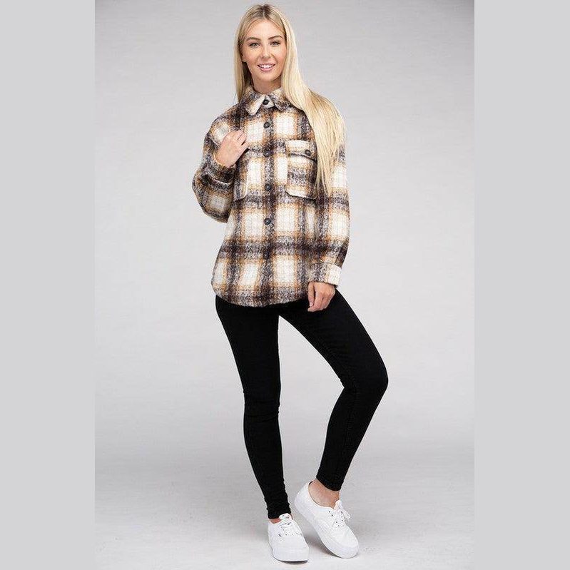 Stylish woman wearing a trendy plaid shacket jacket with a button-up design and front pocket