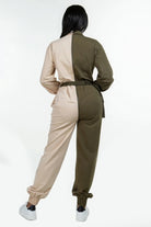 Back view of a women's two tone casual jumpsuit in beige and olive green with a relaxed fit