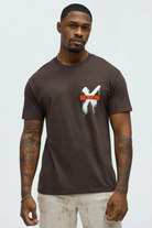 Brown graffiti t shirt men by VacationGrabs with white and orange graphic detail on chest