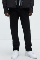 VacationGrabs black urban style jeans for men paired with white sneakers and dark jacket
