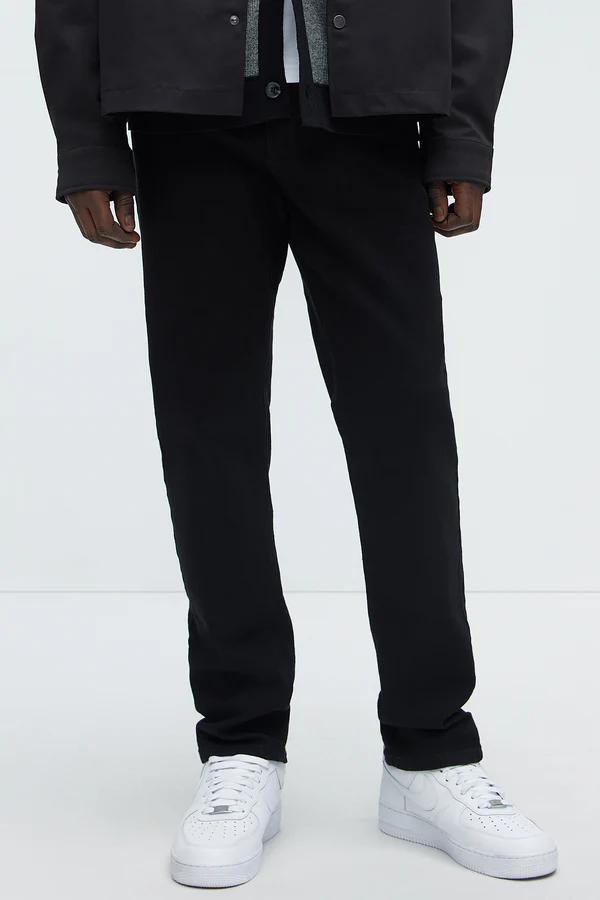 VacationGrabs black urban style jeans for men paired with white sneakers and dark jacket