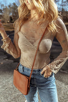 YNIQUE beige lace mesh long sleeve blouse styled with high waisted jeans and tan crossbody bag outdoors