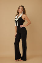 Chic black vacation jumpsuit outfit for women with stylish tie neckline for a trendy look
