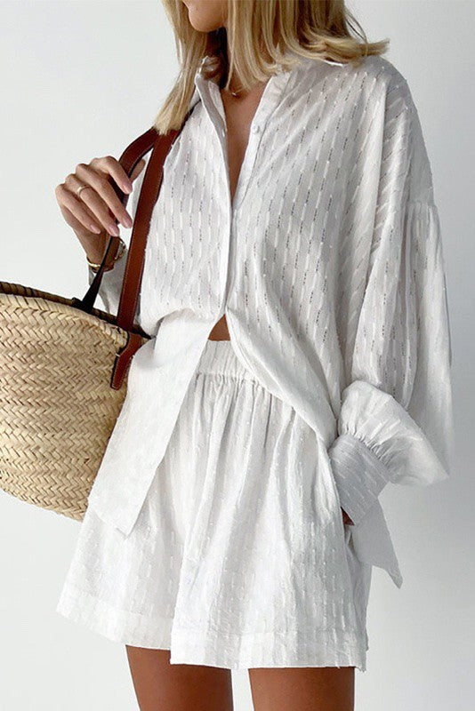 White textured lightweight matching set as a vacation outfit for women with a woven straw bag