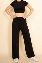 Stylish black crop top and wide-leg pants set, perfect for vacation outfits for women