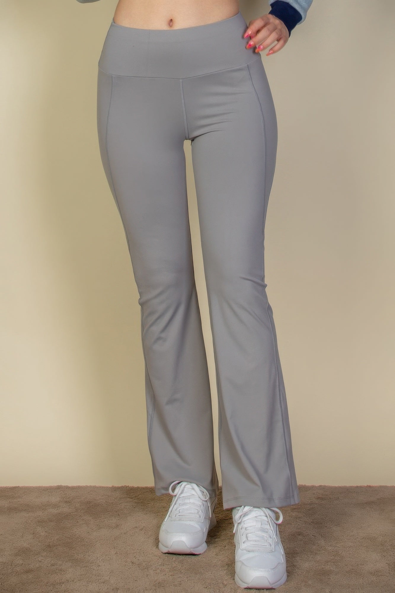 VacationGrabs women's gray vacation style flare leg trousers paired with white sneakers