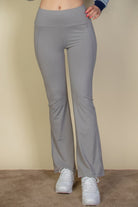 VacationGrabs women's gray vacation style flare leg trousers paired with white sneakers