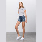 Trendy vacation style women's shorts in classic denim with a stylish distressed finish