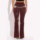 Back view of women's velvet PU flared pants clubwear in deep burgundy color by VacationGrabs