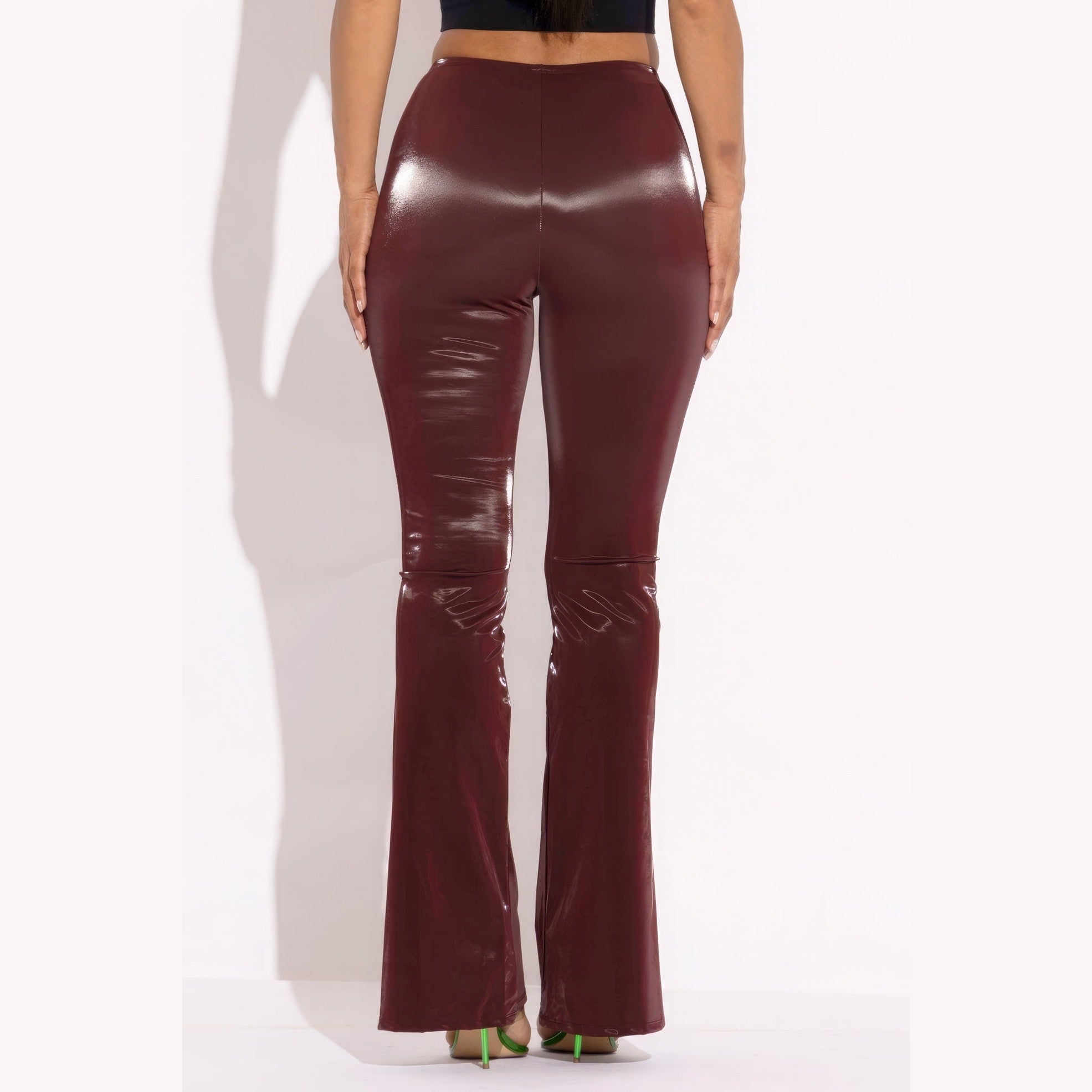 Back view of women's velvet PU flared pants clubwear in deep burgundy color by VacationGrabs