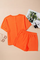 Orange two-piece casual vacation outfit for women with short sleeves and elastic waistband shorts