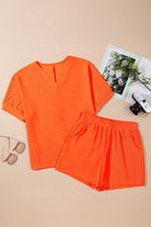 YNIQUE bright orange casual vacation outfit for women with V-neck top and elastic waist shorts