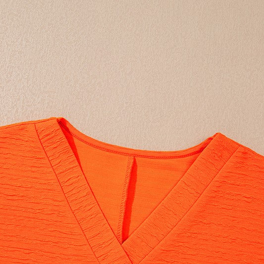 YNIQUE bright orange textured v-neck top perfect casual vacation outfit for women